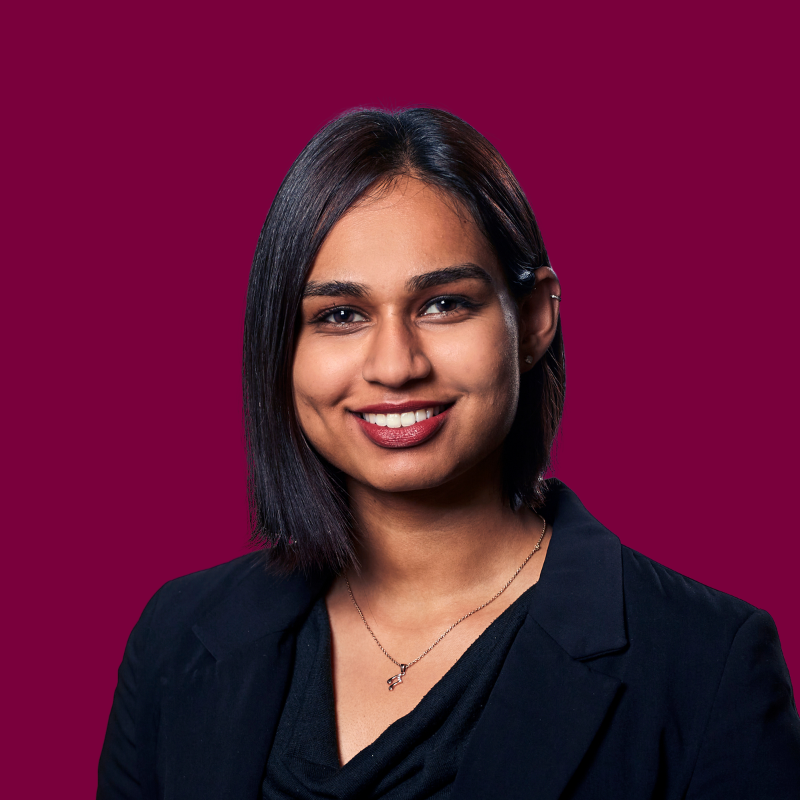 Headshot of Samantha Daniel, a smiling woman with a short dark hair, wearing a dark blazer.